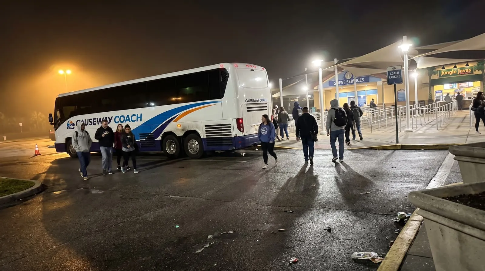 Causeway Coach motorcoach staged for a late-night pickup after an Orlando seasonal event
