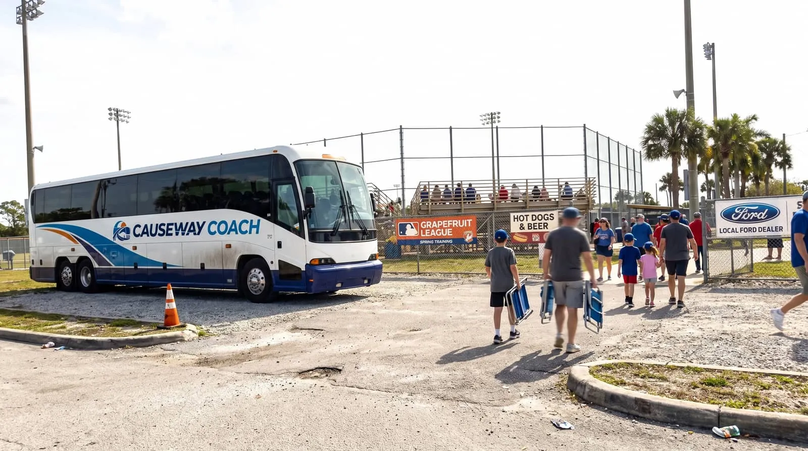 Causeway Coach motorcoach dropping a fan group at a Florida spring training ballpark entrance