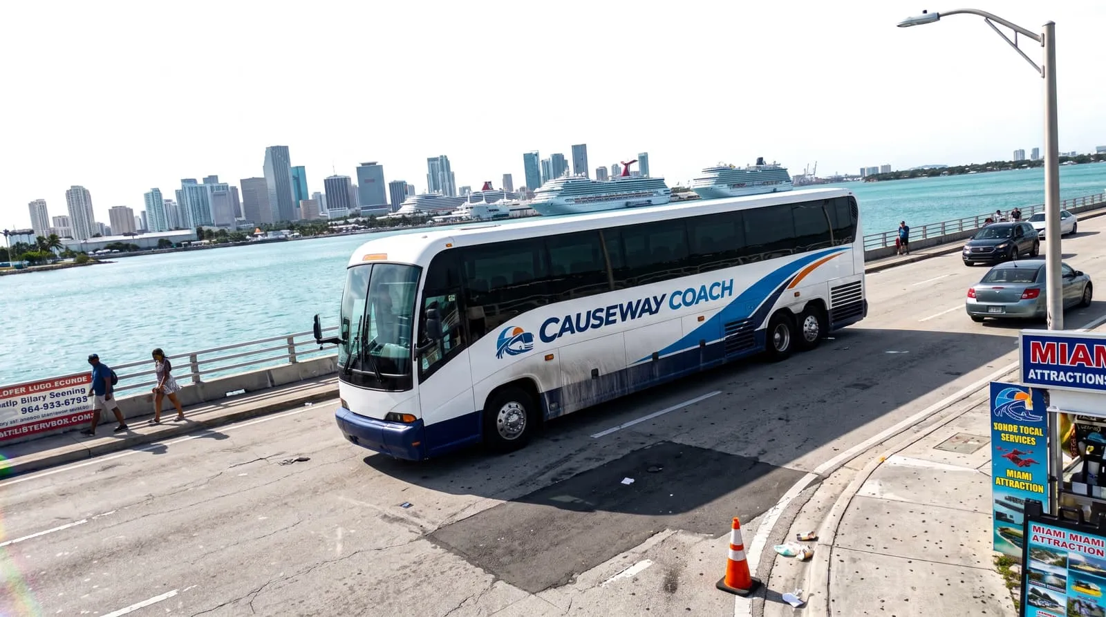 Causeway Coach motorcoach on a Miami causeway with the downtown skyline behind it